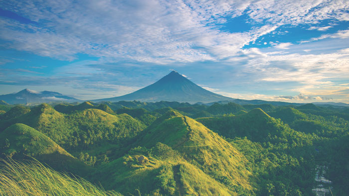 A mountain with a large peak in the distance.