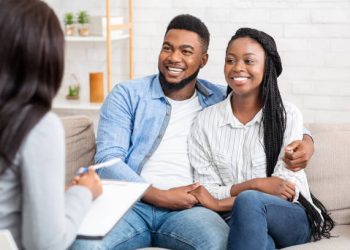 A couple sitting on the couch with an advisor.